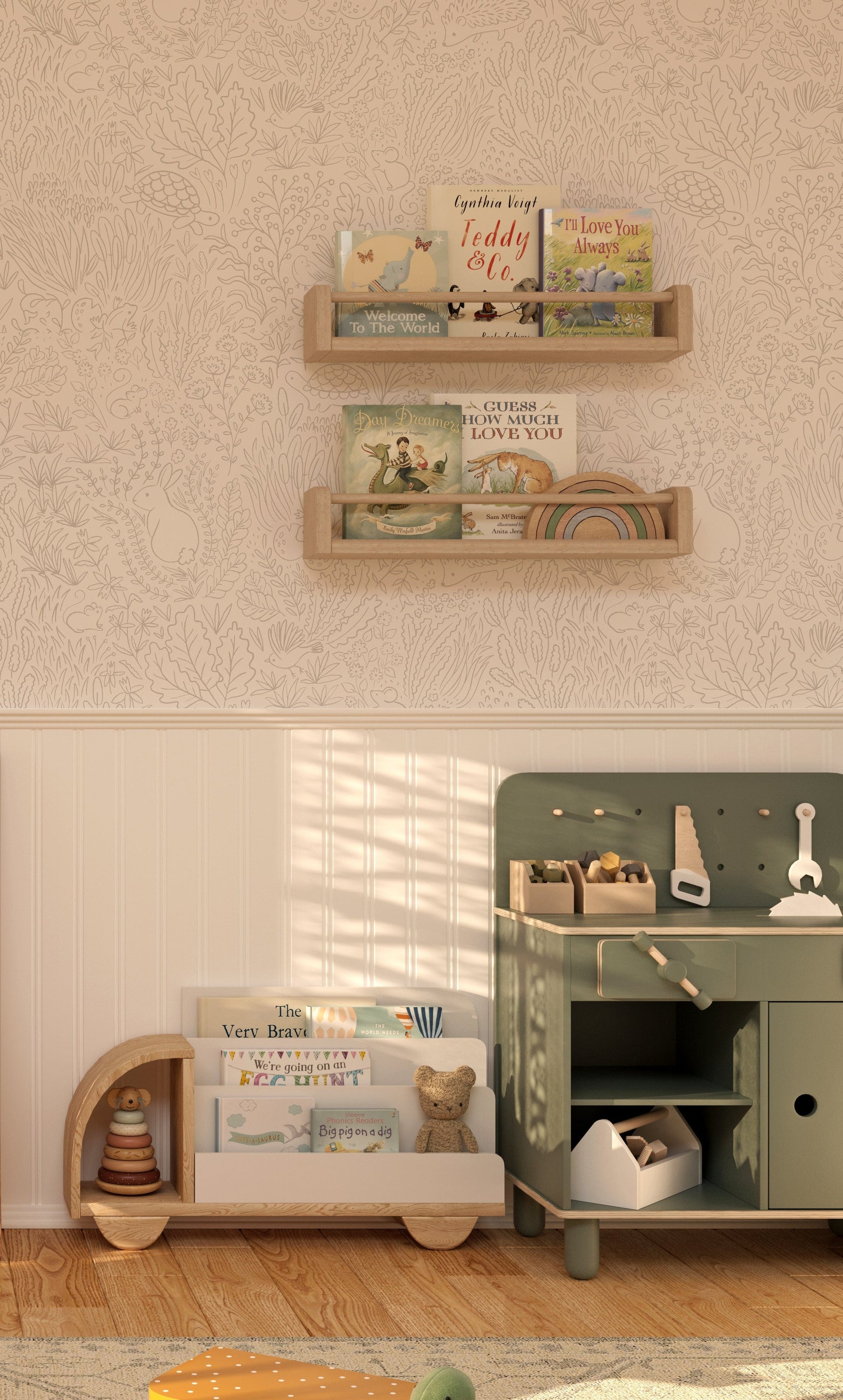 Green wooden toy kitchen and white wooden book shelf in front of a wall wil white panelling at the bottom and the garden doodles wallpaper at the top.