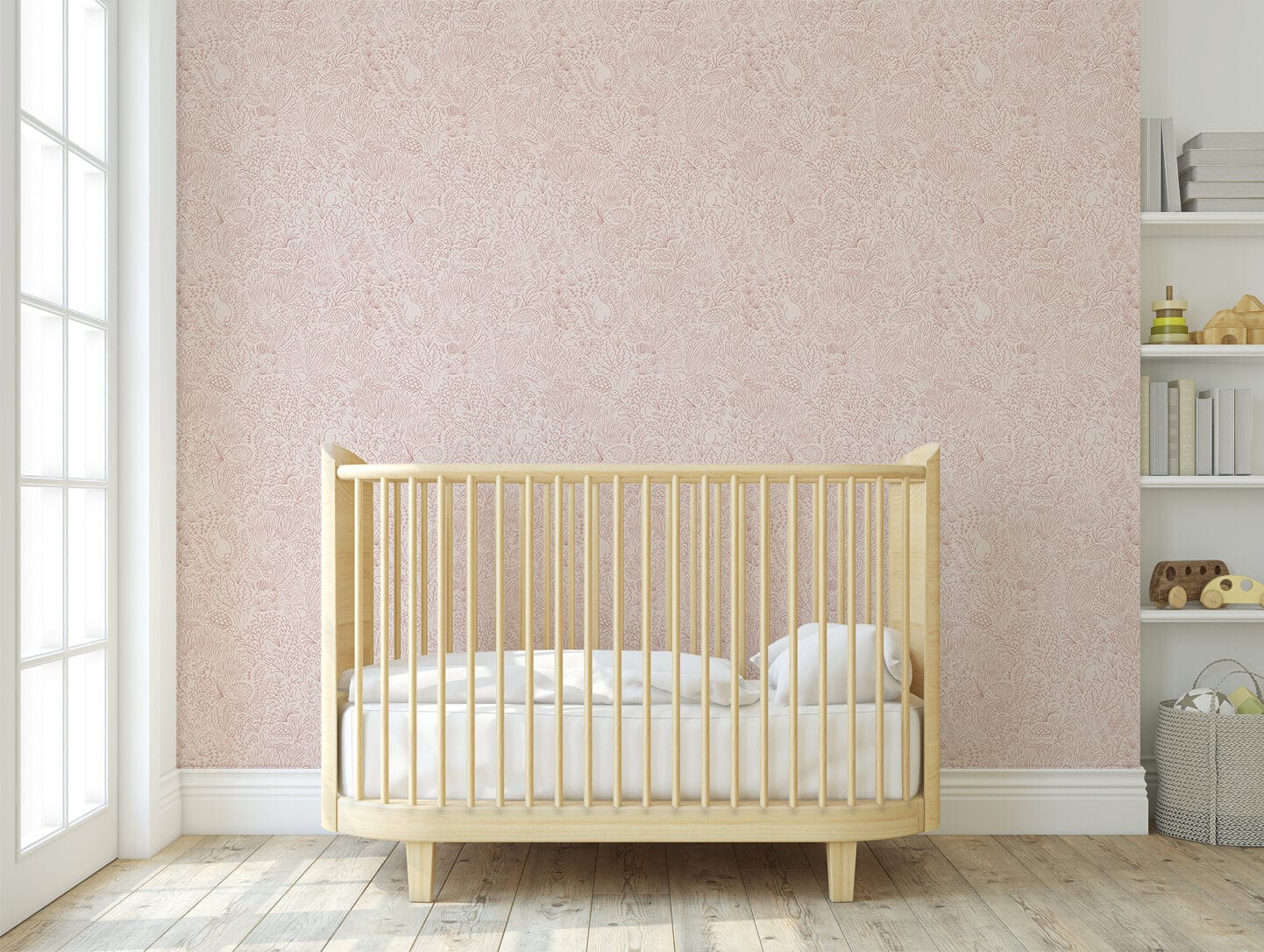 A light wooden cot with white bedding in front of a wooden multi window door in front of a wall papered with our garden doodles pink wallpaper