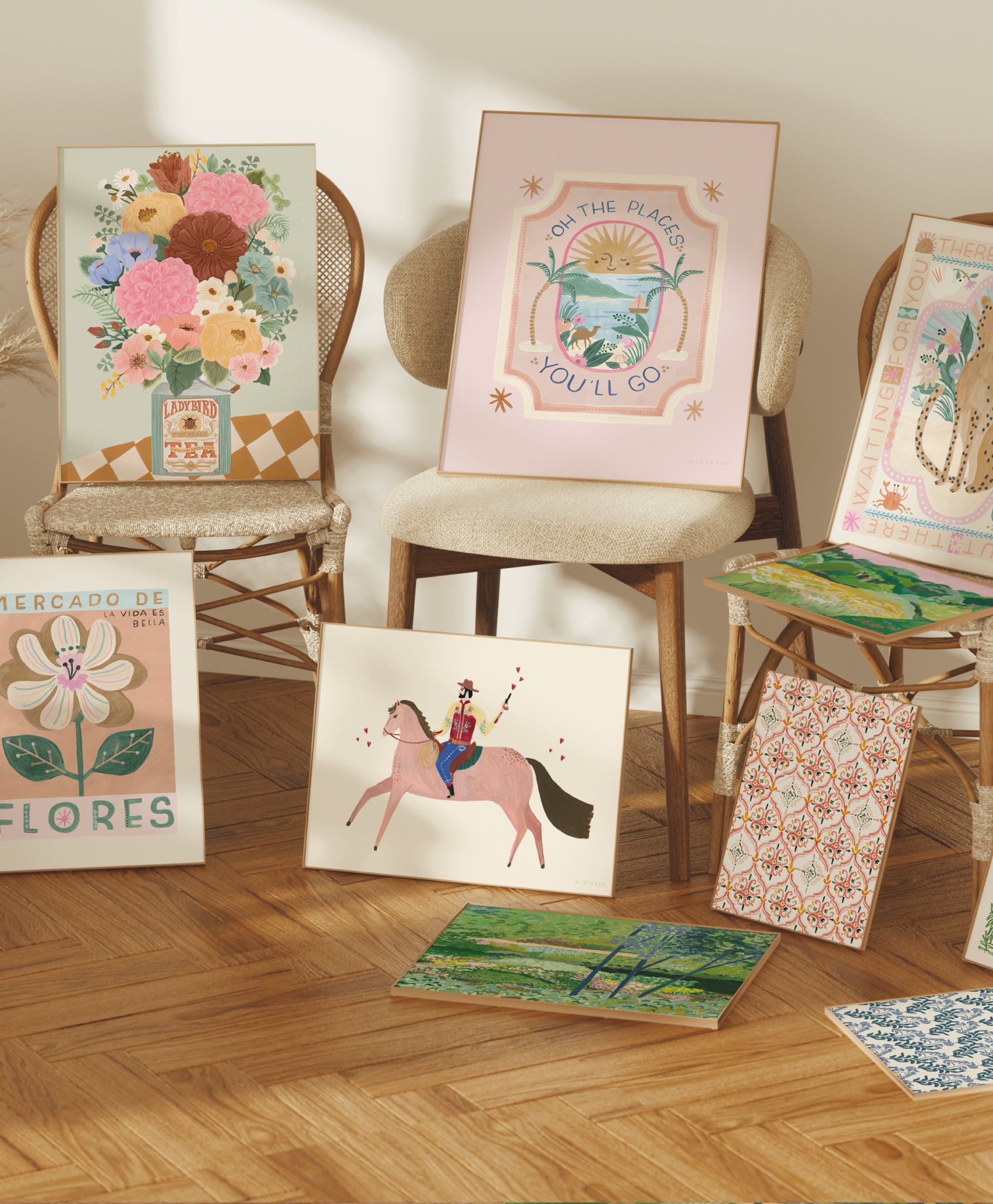 Banner showing art prints from the wild bohemia collection propped up against and on chairs