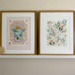 A white shelf with booties, a I'm here round plaque, a wooden flag with 'AUTUMN' on it, and 2 complimentary framed art prints, Oh, the places you'll go and Crayon Wilderness.